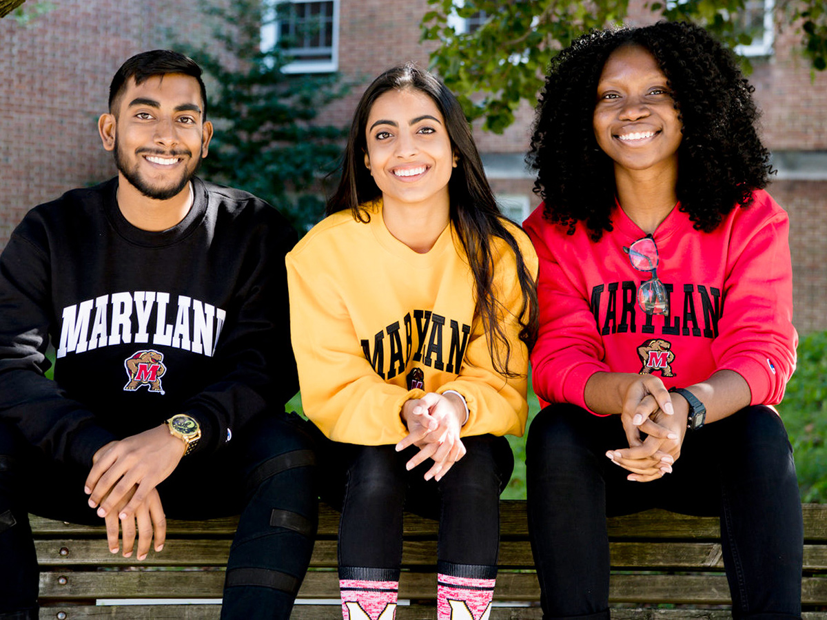 One male and two female UMD students wearing Maryland sweatshirts.